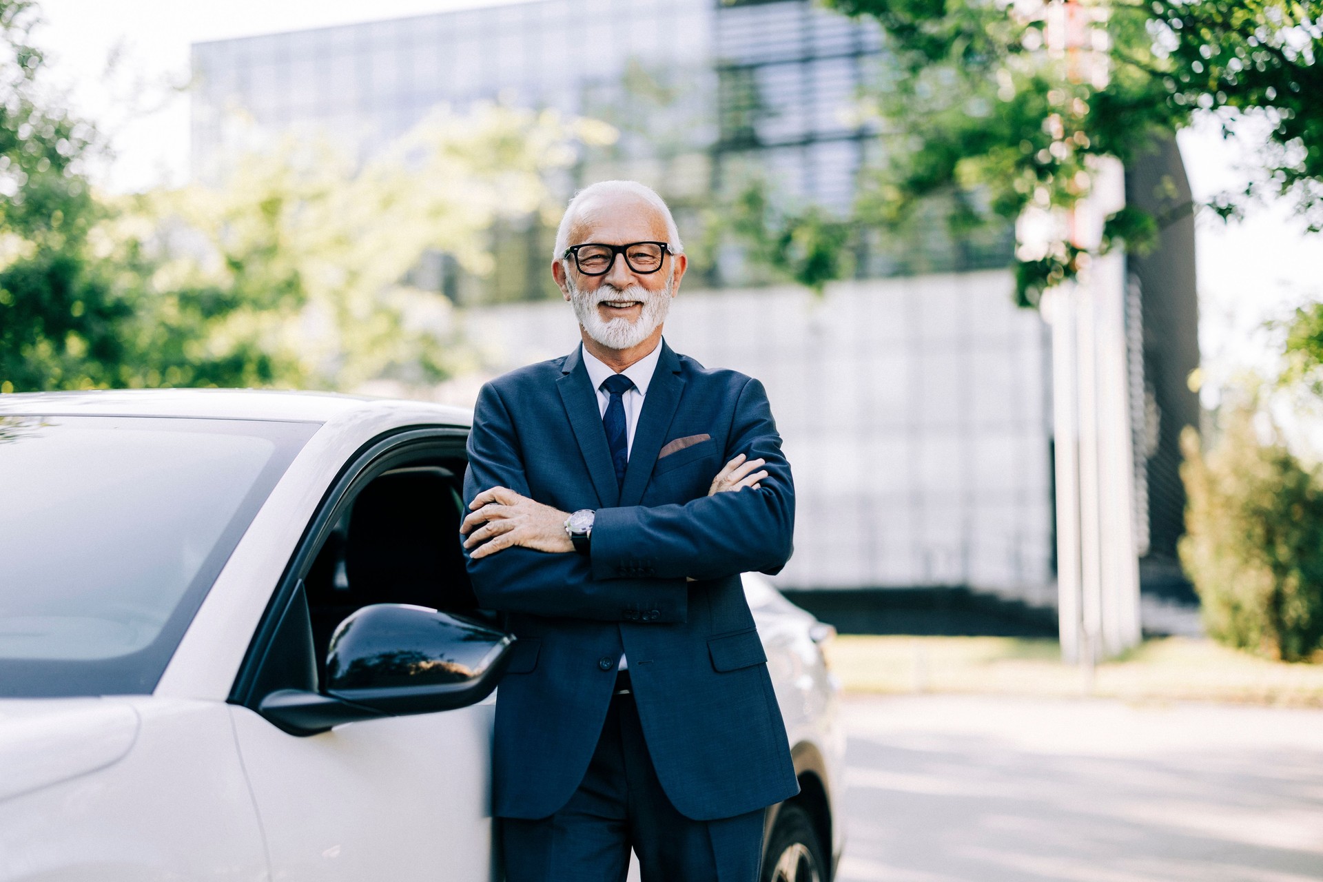 Professional driver is standing next to the car